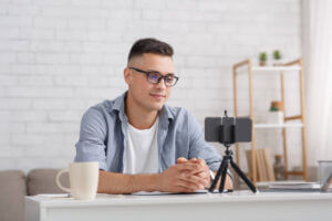 a man sitting at a table with a camera